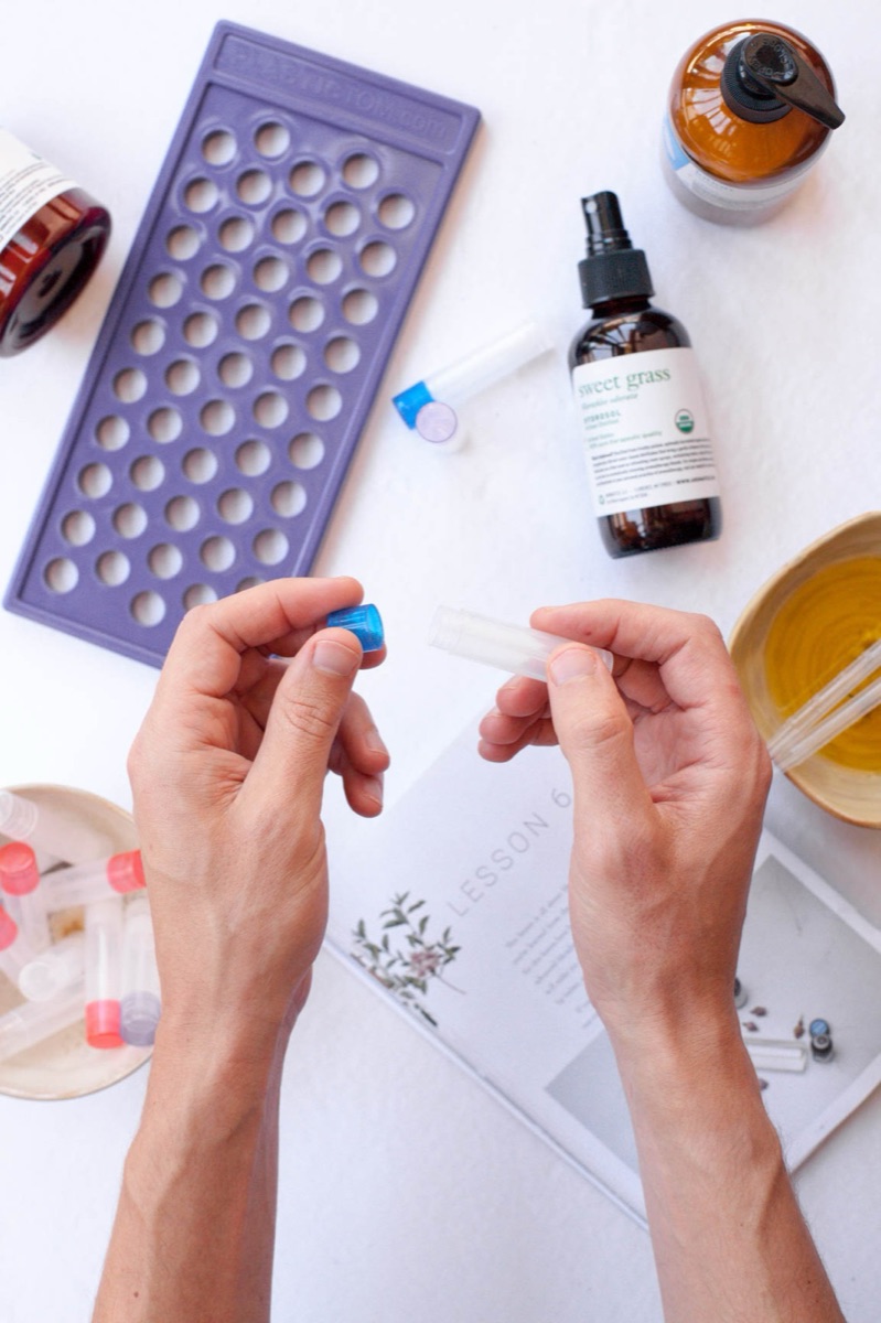 Hands filling an aromatherapy inhaler during a make-along